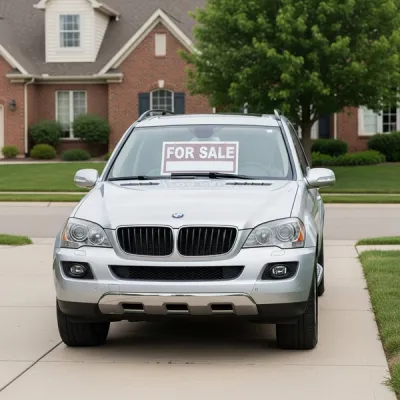 A late-model silver SUV parked in a well-lit suburban driveway with a for-sale sign placed inside the front window, representing a vehicle subject to legal repurchase.