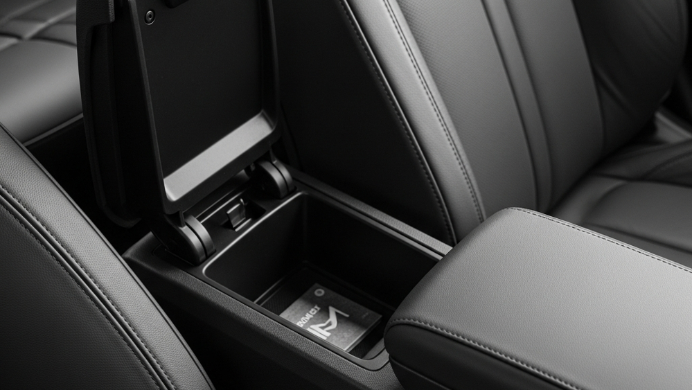 A detailed view of a modern car's center console with the storage bin and armrest inside the front cabin.