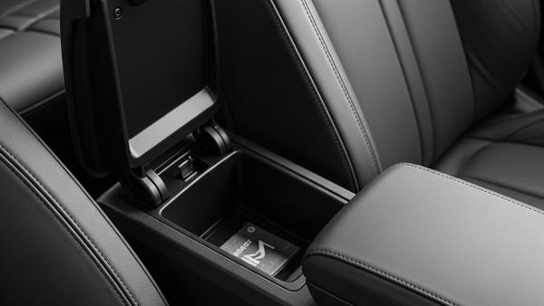 A detailed view of a modern car's center console with the storage bin and armrest inside the front cabin.