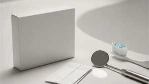 Sublingual medication strips in a generic box sitting next to a professional dental mirror and toothbrush on a clean bathroom counter.