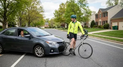 A suburban Maryland road where a car has come to a stop just inches from a bicycle, illustrating a moment of successful accident avoidance and legal last clear chance.