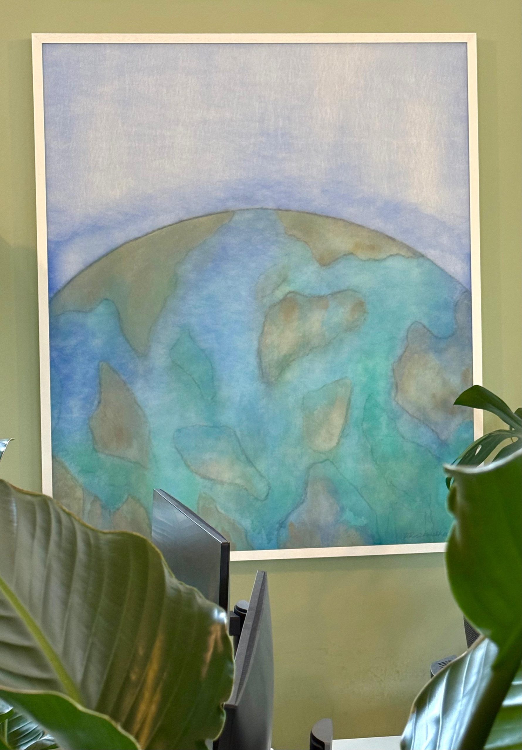 A soft blue planet above a desk with monitors and plants.