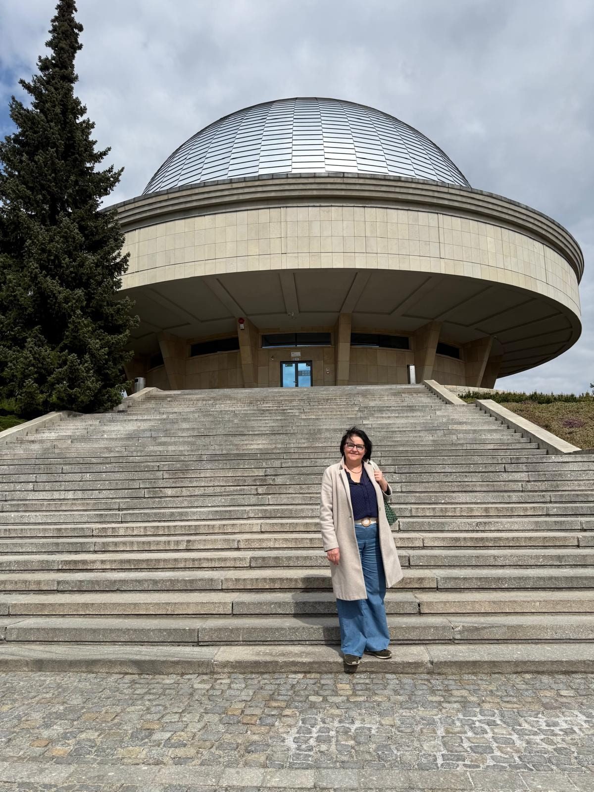 The artist on the approach steps to the entrance of the planetarium.