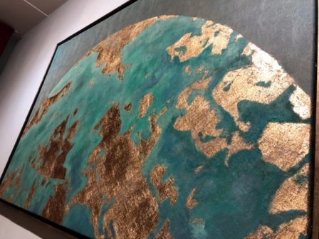 The earth seen from a great distance, in blue and gold.