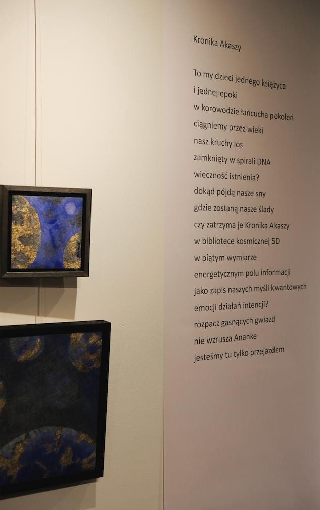The poem Kronika Akaszy on the wall, two small framed works beside it.