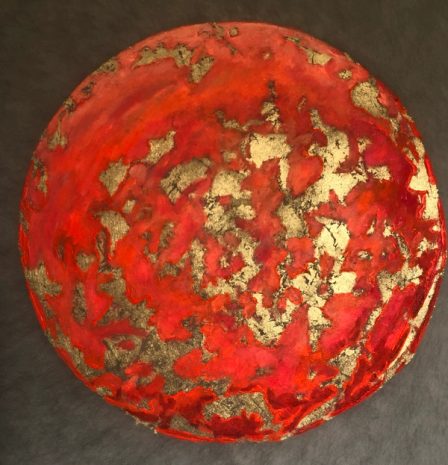 A planet in warm tones with golden accents.