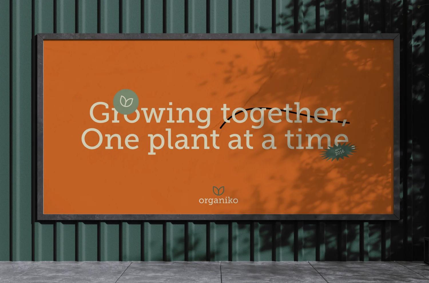 Organiko billboard with an orange field and a nature-led brand message