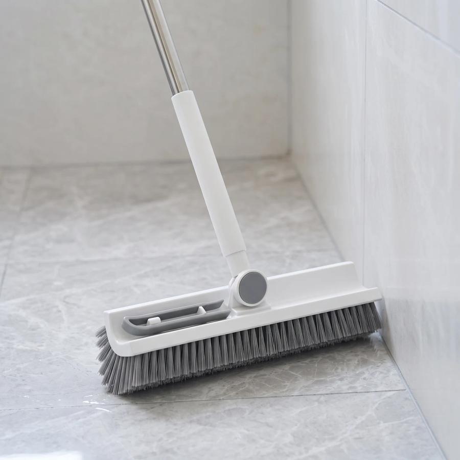 White and gray brush head beside a floor edge