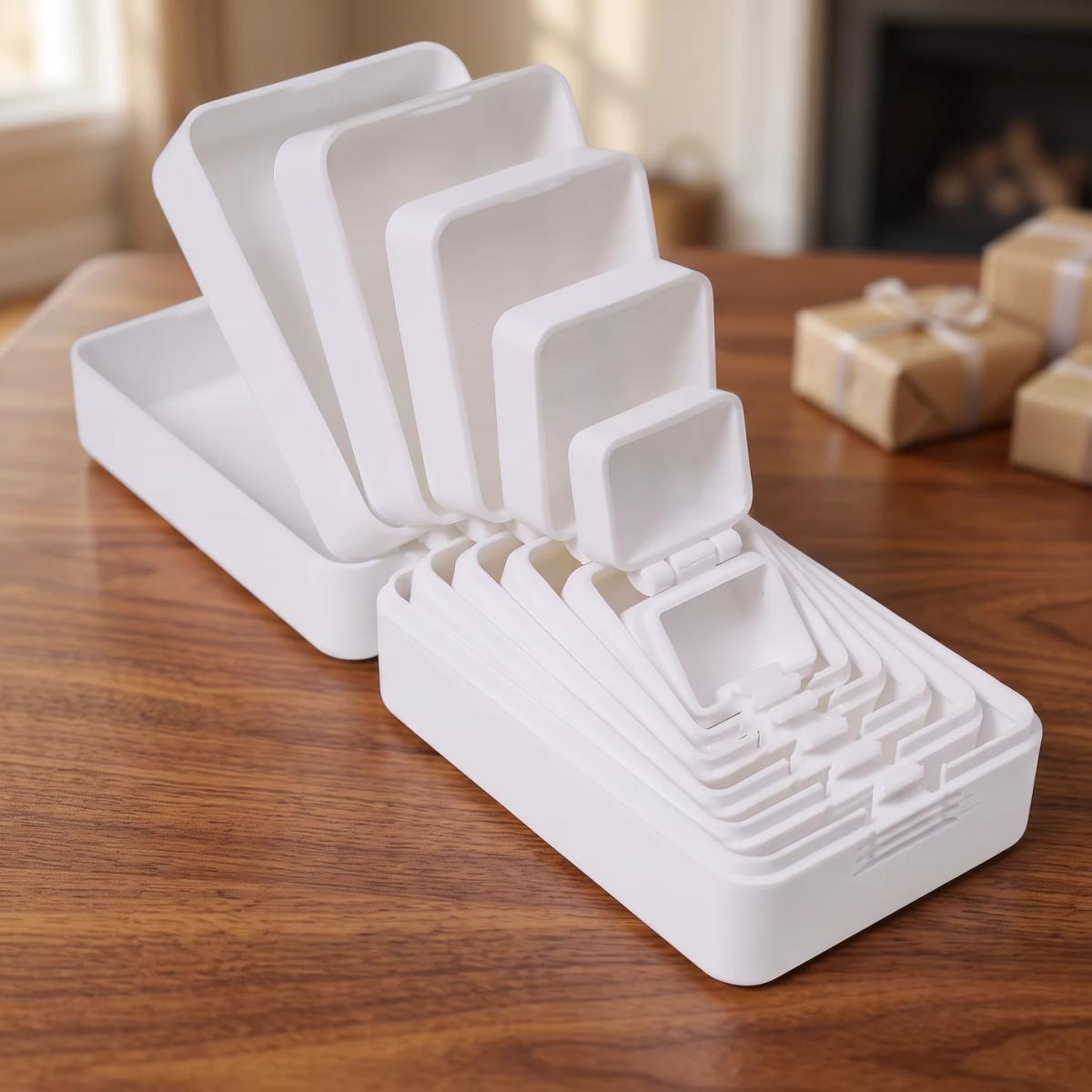 Open White nesting prank box on a coffee table; props are not included
