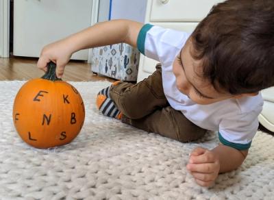 Practicing Letter Recognition with a Pumpkin and Dry Erase Marker 