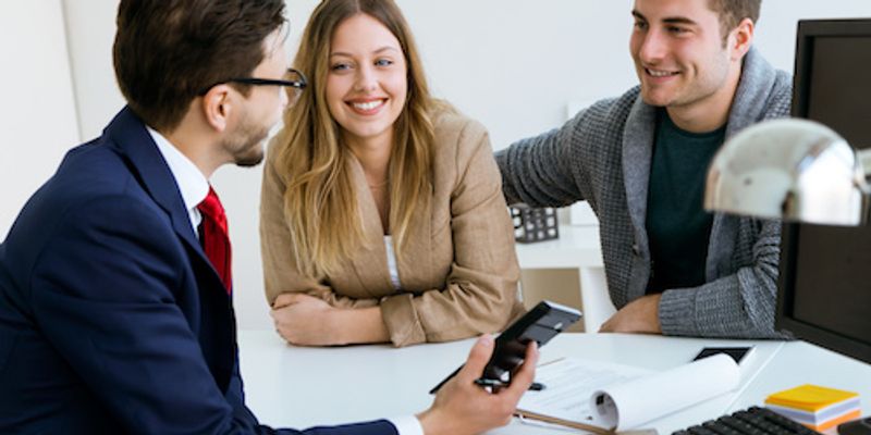 Couple discussing VA loan eligibility with mortgage lender.