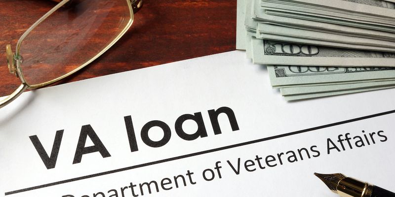 VA loan document with pen and money on the table.