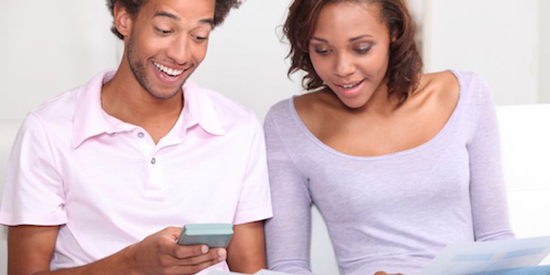 Couple computing VA loan closing costs.