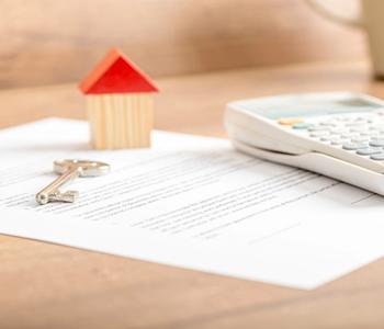 VA Loan documents with key and calculator.