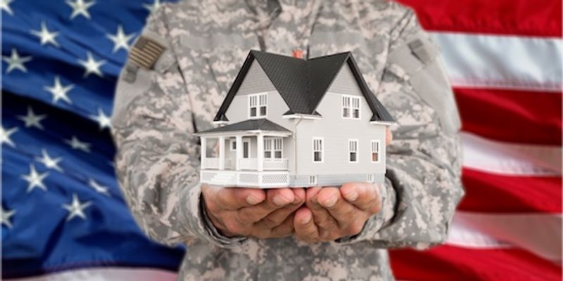 Military holding VA Home Loan concept in hand.