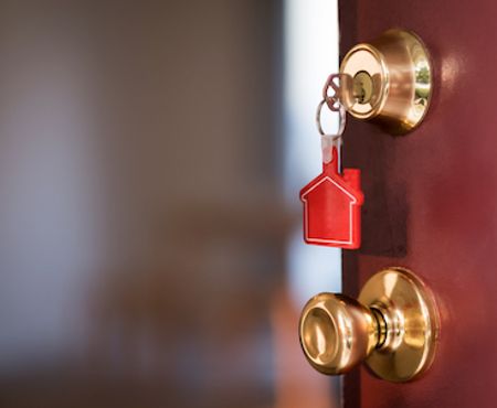 Opening door with a house key.
