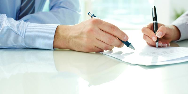 Signing document for VA loan application.