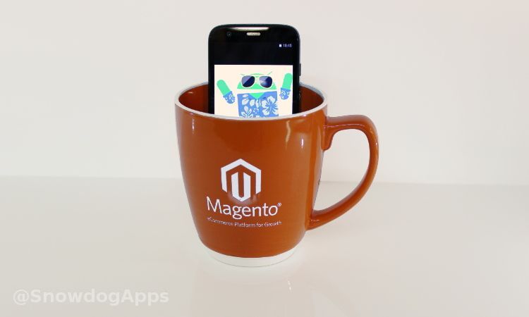 A smartphone in a cup with Magento written on it