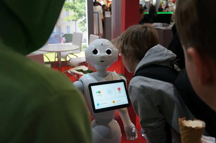 Pepper chatting with kids at Tour Salon fair in Poznań