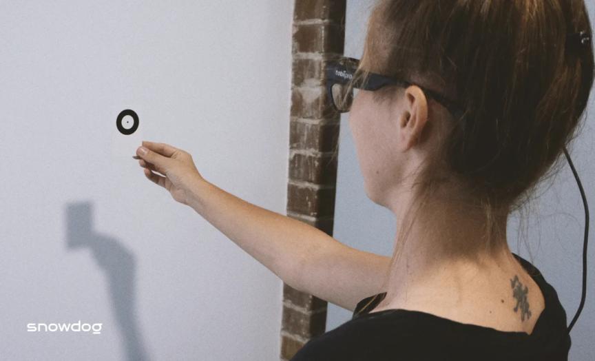 A calibration of the glasses performed before the research - girl handling paper card to calibrate glasses.