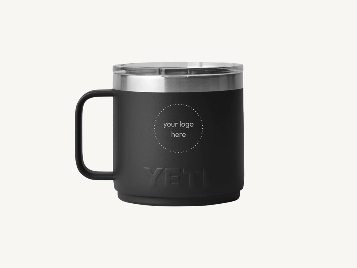 A branded YETI mug, the kind of piece that anchors a corporate gift box.