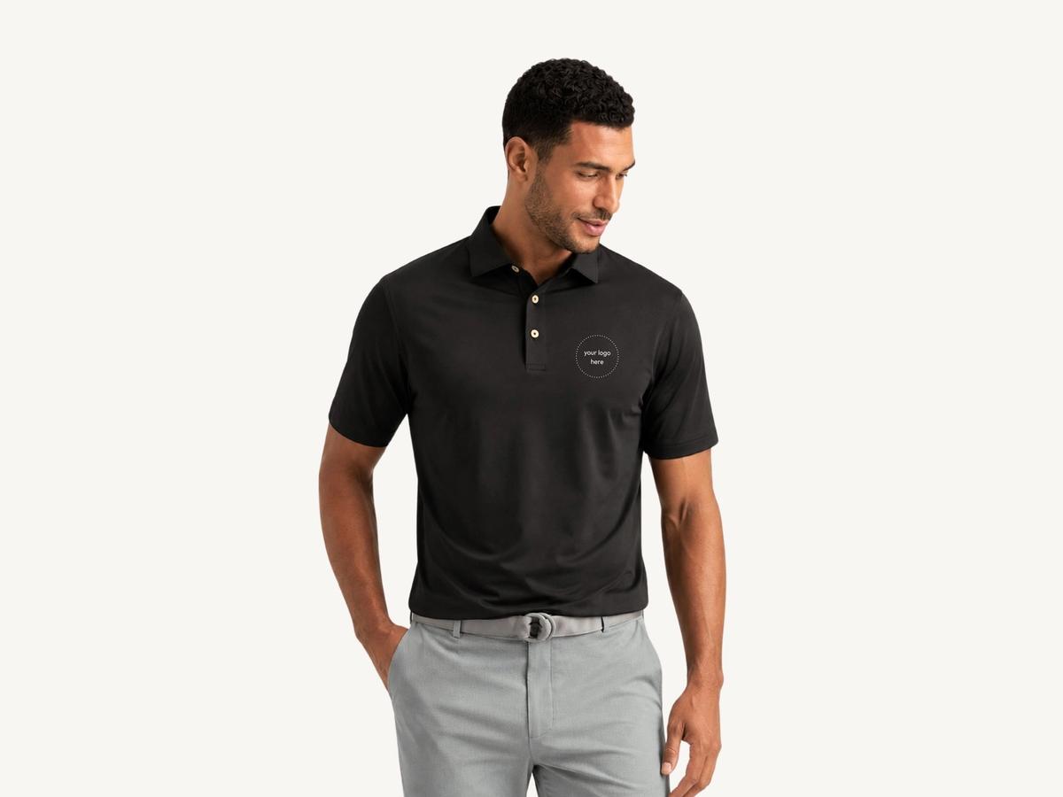 Peter Millar Solid Performance Polo on a cream background, ready for an embroidered company logo.