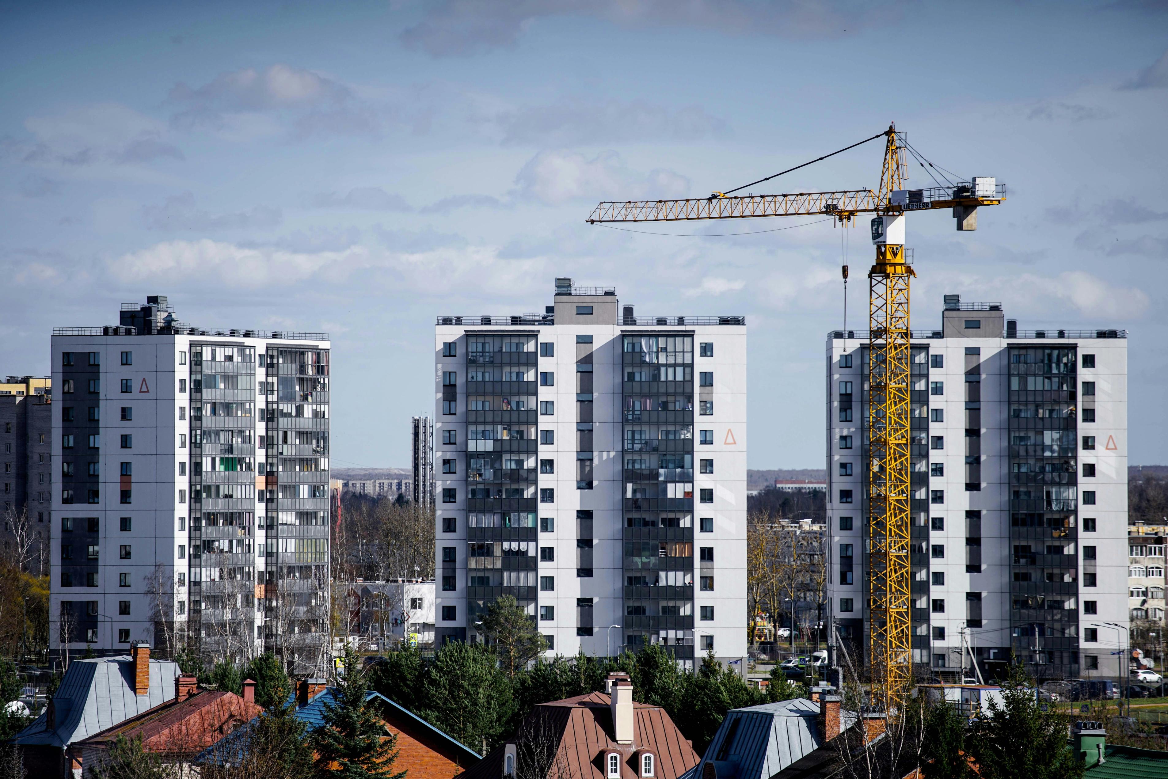 Clădiri rezidențiale în construcție cu macara turn care ilustrează aplicarea reglementărilor DPP în construcții.