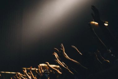 hands reaching out at a concert