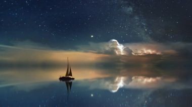 A small sailboat on calm water with the reflection of the nigh sky 