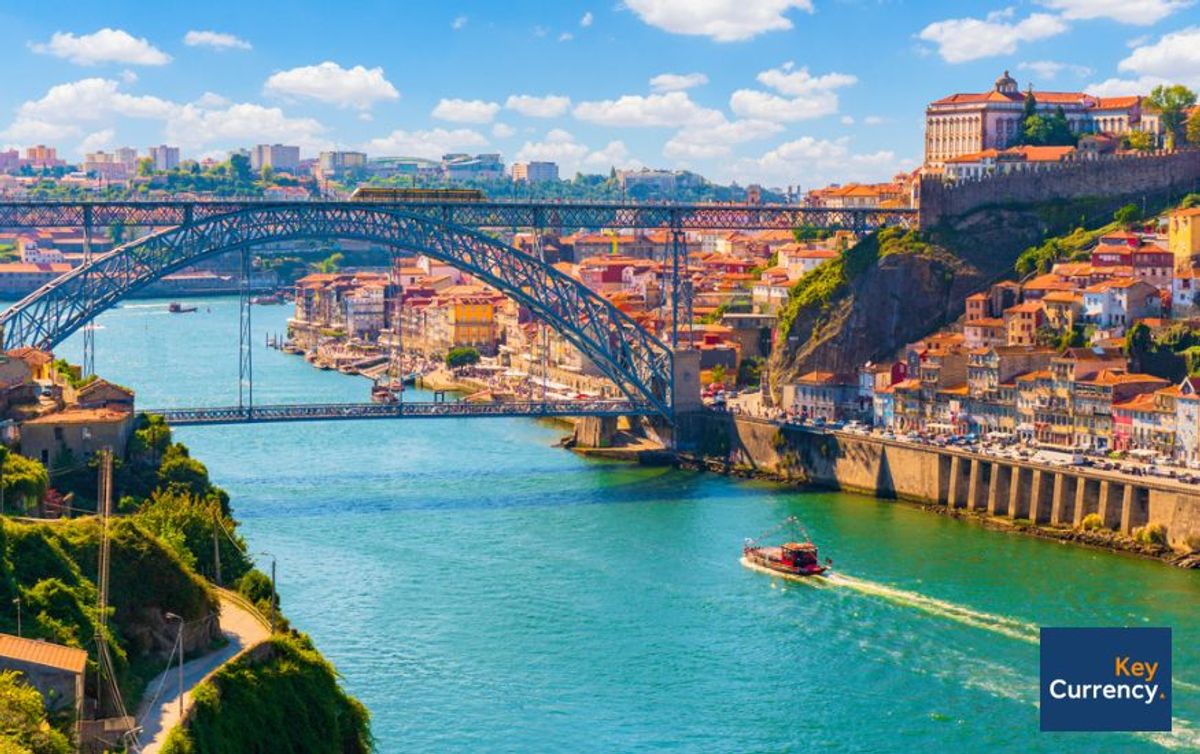 Photograph of bridge in Porto, Portugal, on a warm sunny day. 