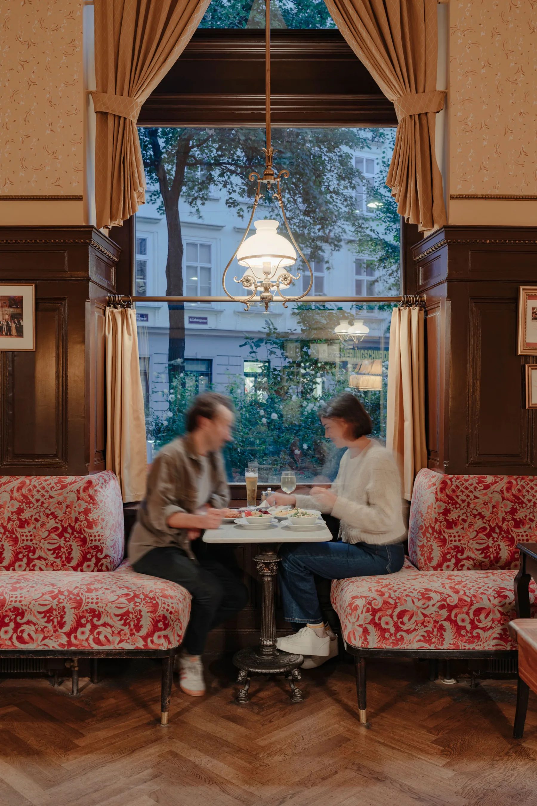 Gäste im Café Sperl an einem gedeckten Tisch