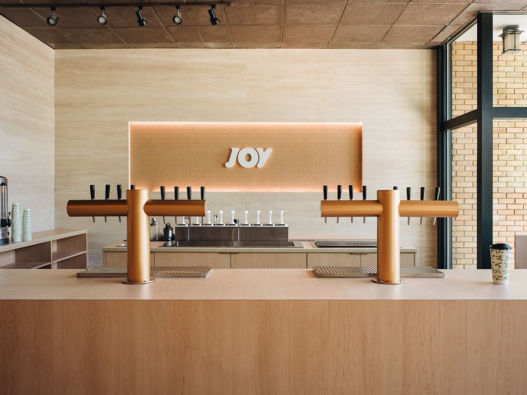 Joy Tea River Forest counter with copper tea taps and the JOY sign