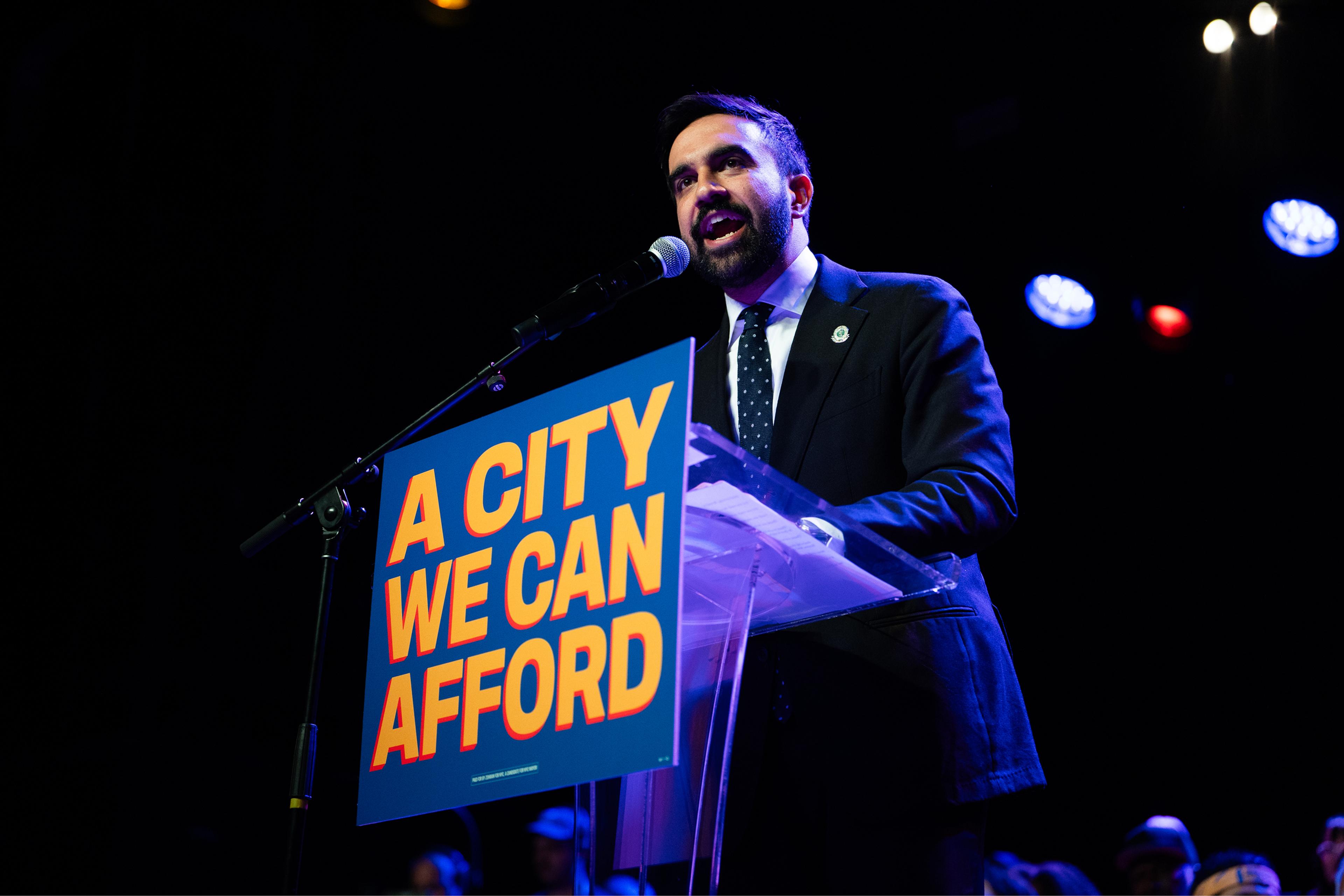 Zohran Mamdani speaking on stage at his "A City We Can Afford" rally