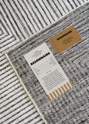 A close-up of the product tag on a Resonnaire rug