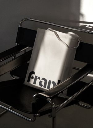 A tote bag with the Frank logo on it