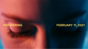 A close-up of a person's face lit by red and blue light overlayed with the text "PREMIERING FEBRUARY 11, 2021"
