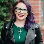 Image of a girl with purple hair, a green shirt and a leather biker jacket named Jenn Junod