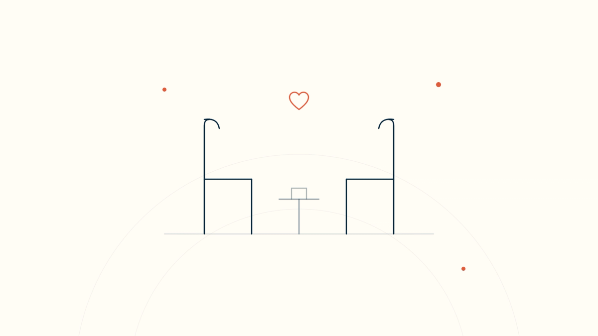 Two chairs facing each other with a small table between them and a heart above — presence in palliative care conversations.