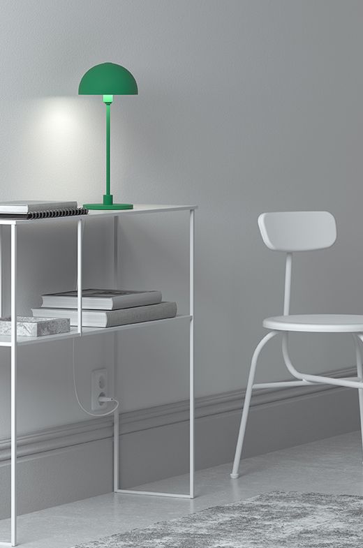 Green table lamp on white table