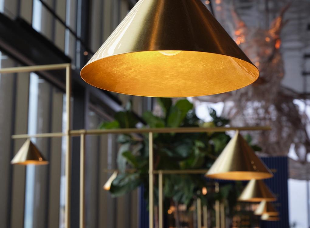 Sleek industrial brass lamp at Brasserie Draken 
