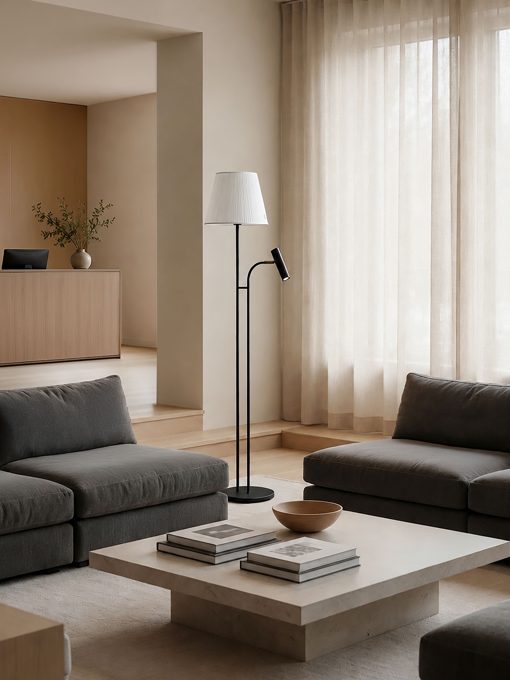 Slender floor lamp in bottle green and brass beside a sofa