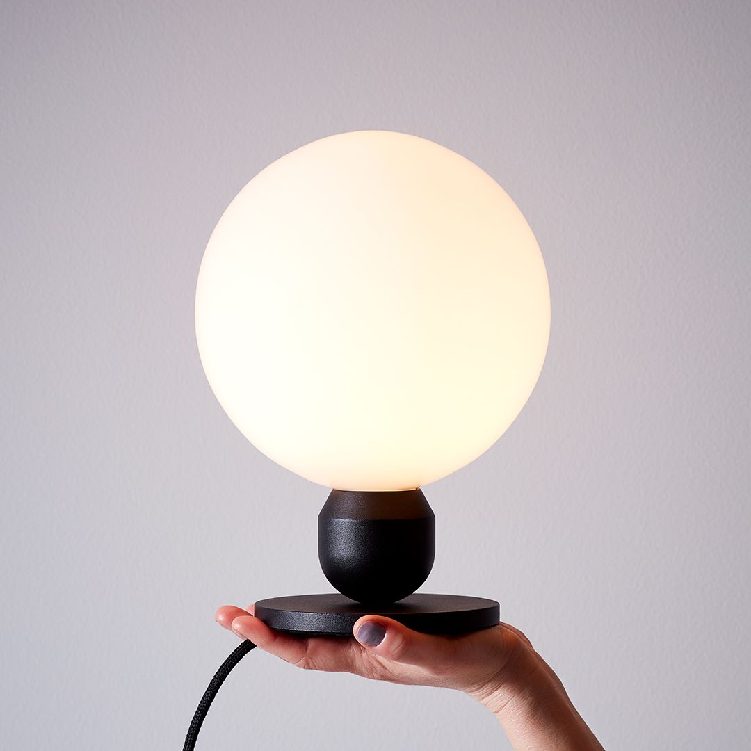 Table lamp black in hand