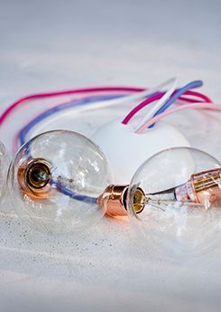 Two lightbulbs with colourful lamp cords