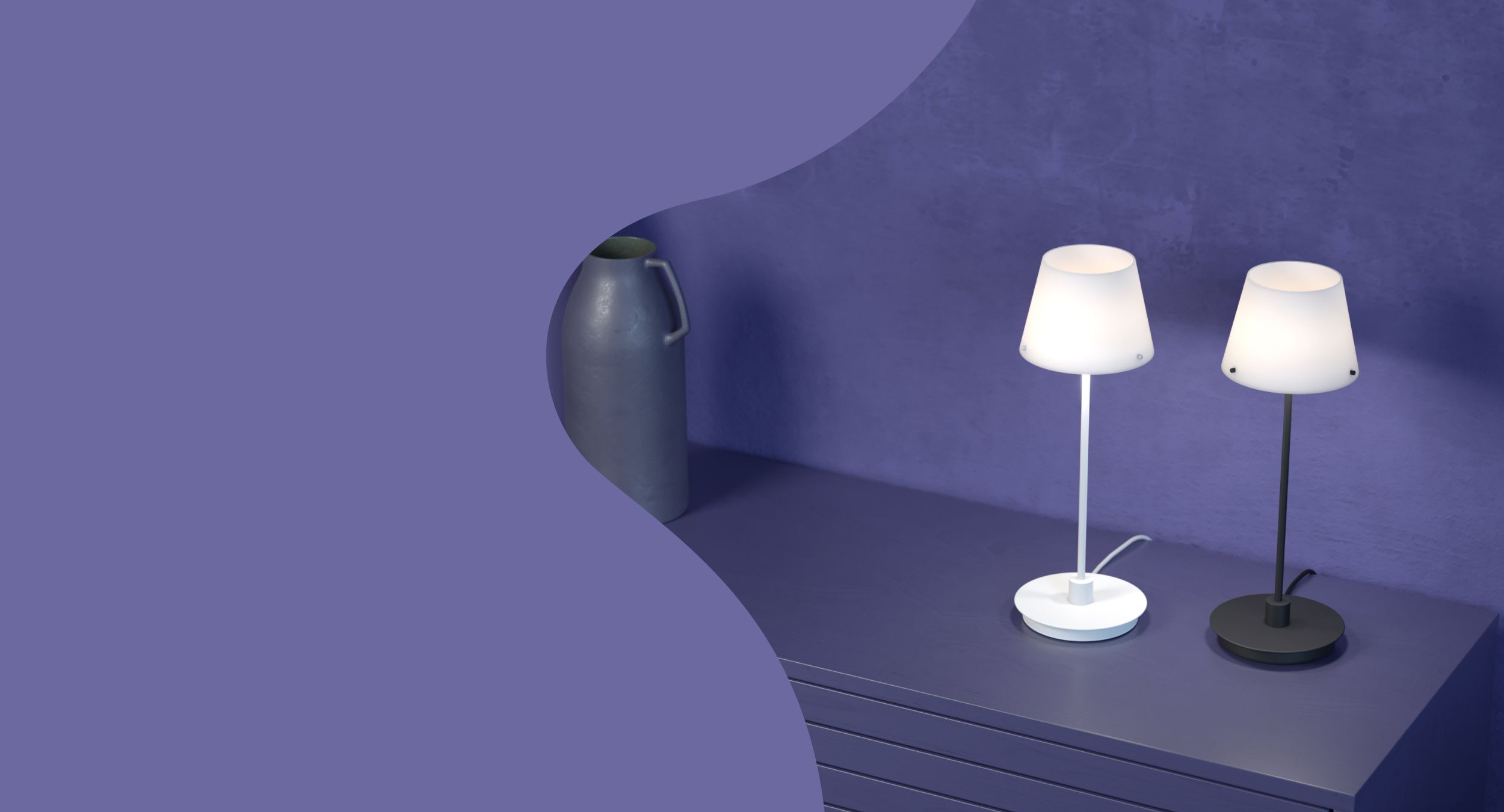 Two table lamps on a side table in a purple room