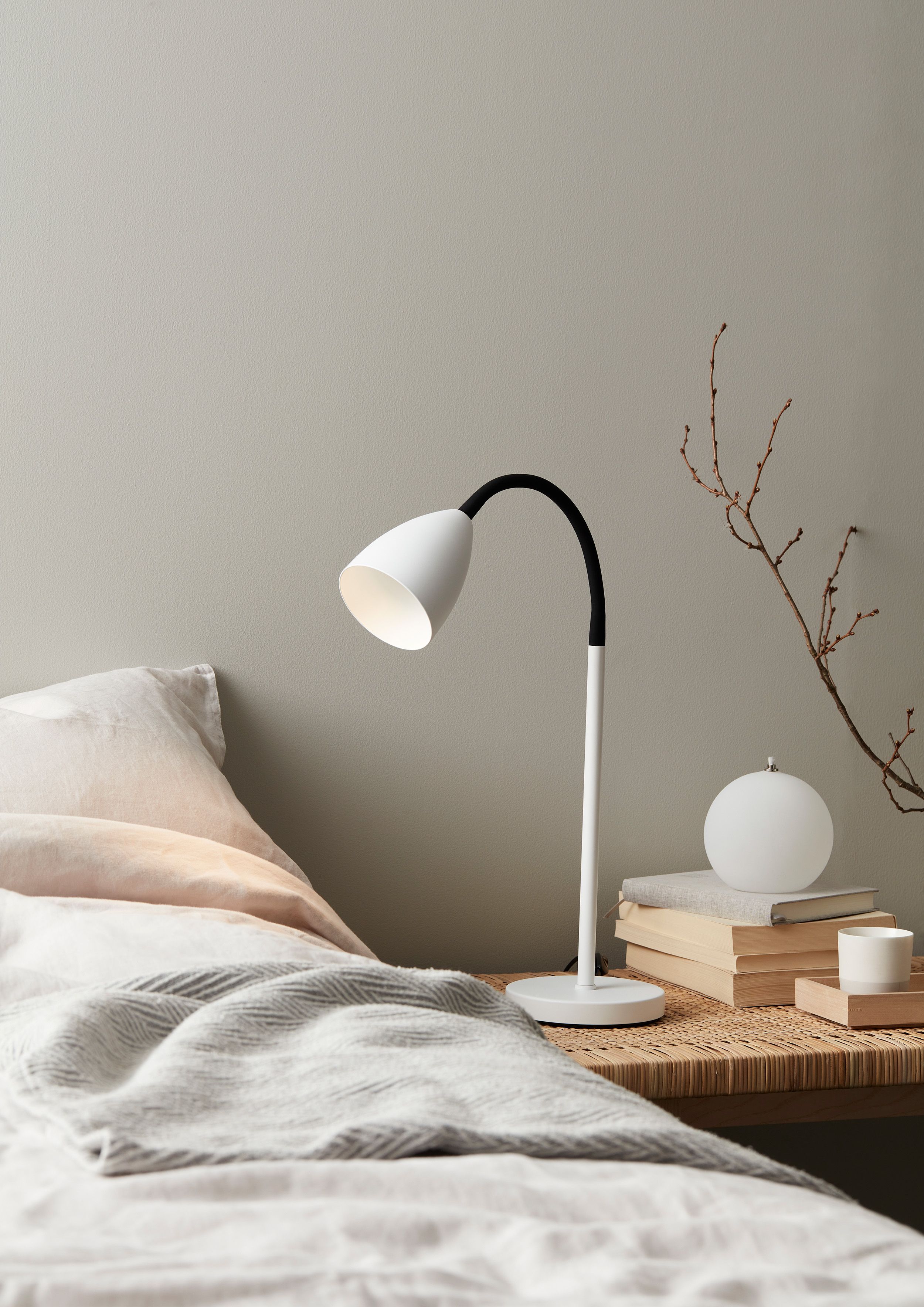 White table lamp beside the bed 