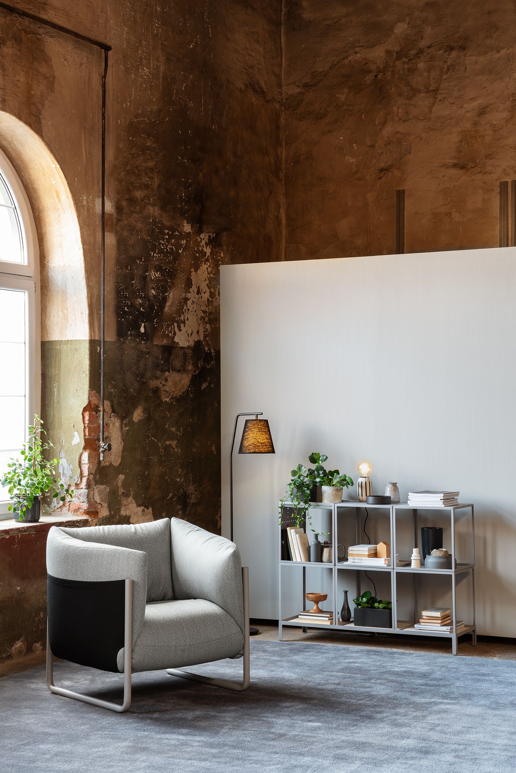 Armchair, floor lamp and side table in a big room