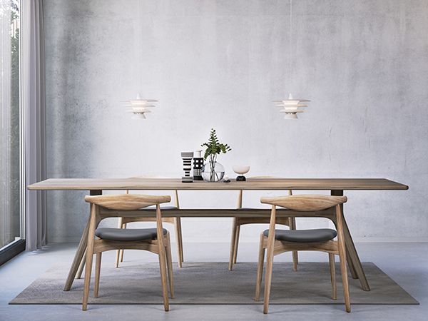 White pendant with three shades over an kitchen table in oak