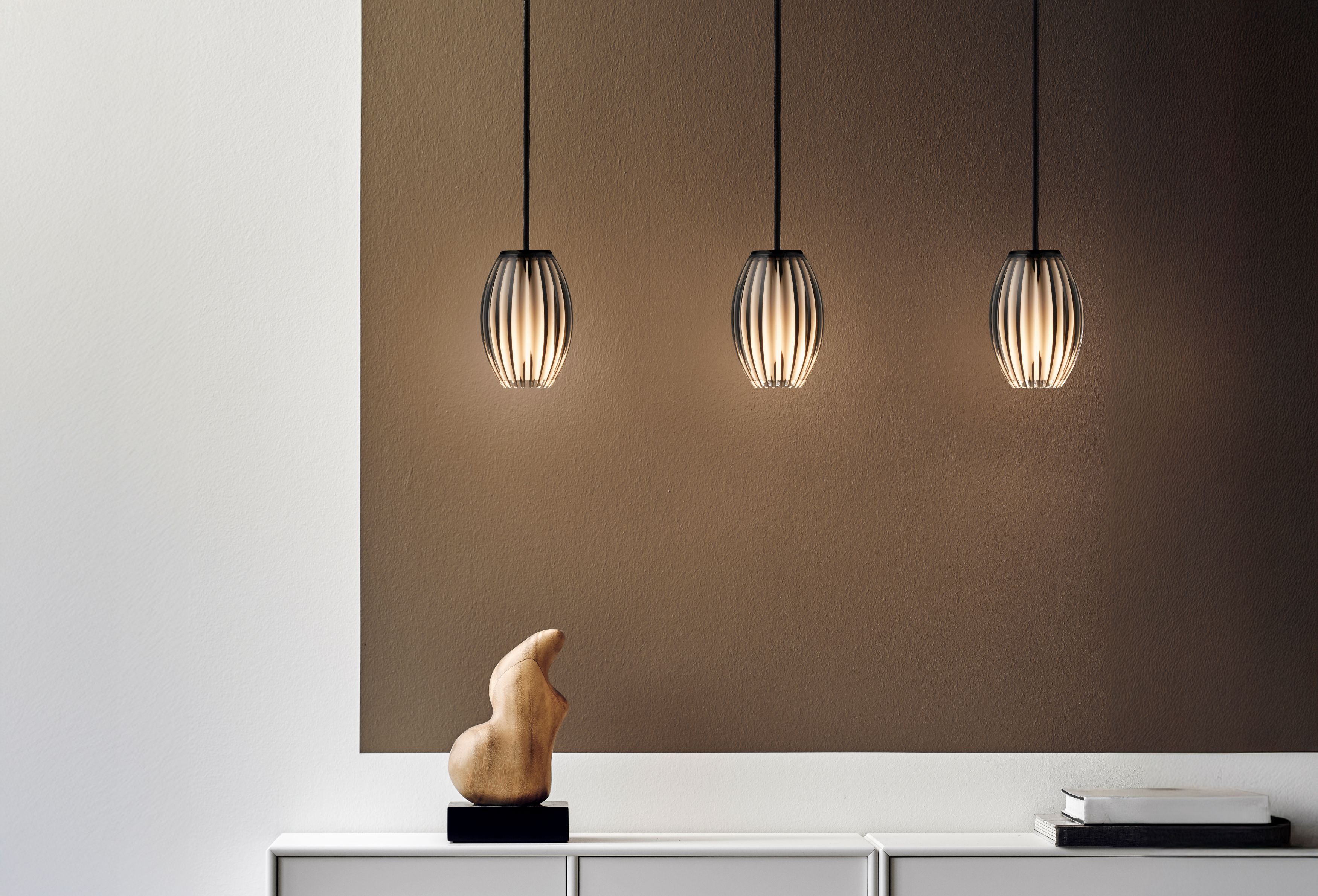 Pendant lamp in smoke acrylic over a desk