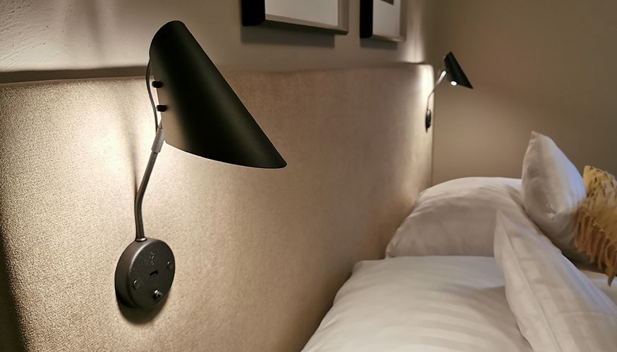 Wall lamp with USB on a bed