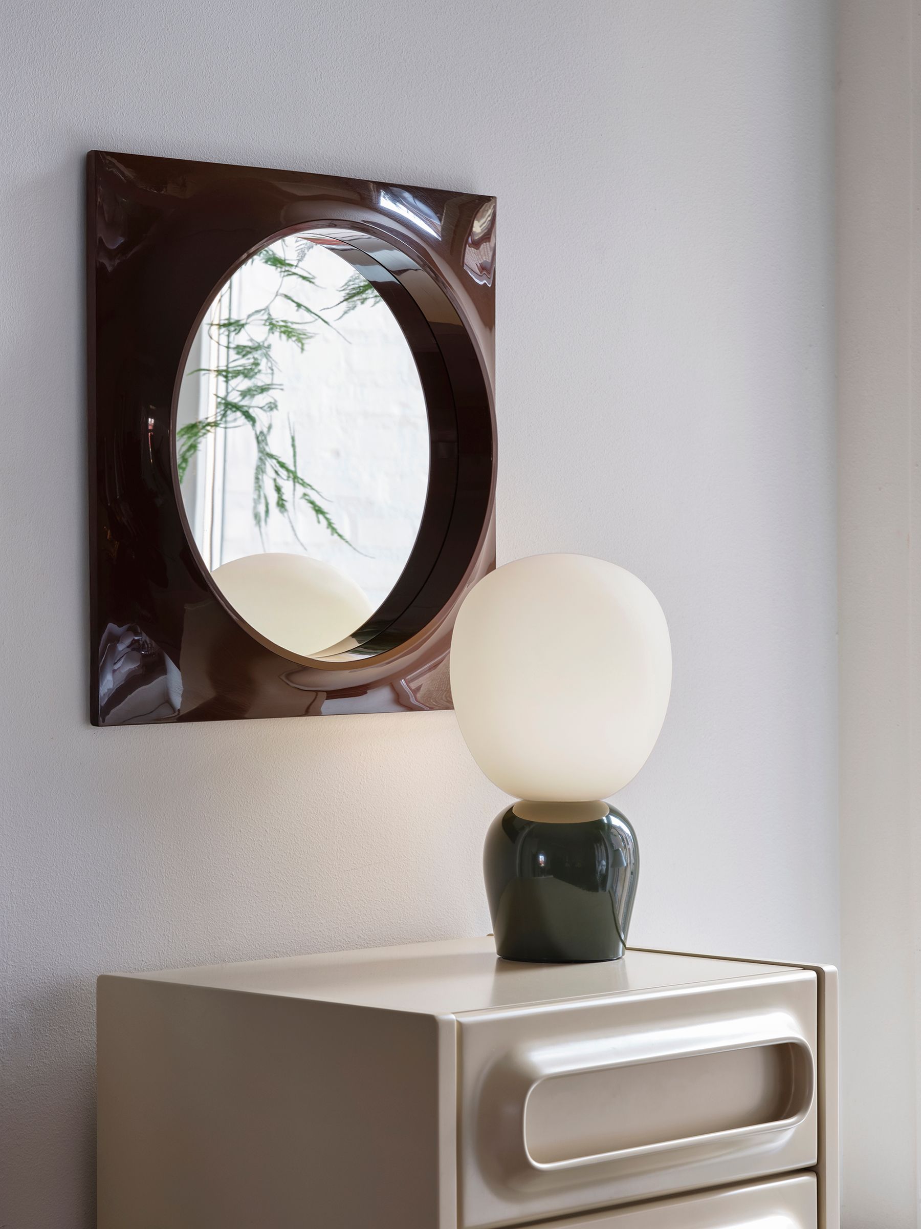 Buddy table lamp in glossy forest green on a dresser
